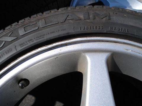 1979 Ford Bronco - A close-up view of a tire and wheel assembly, showing tire brand and specifications.