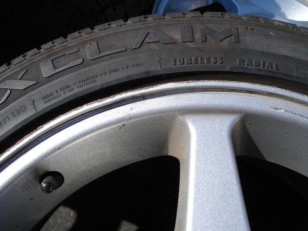 Close-up of a tire with 'CLAIM' and 'TUBELESS RADIAL' visible