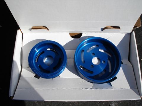 1979 Ford Bronco - Two blue pulleys are shown inside a white cardboard box, with text visible on one of them.