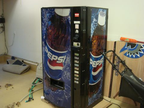 1979 Ford Bronco - A Pepsi vending machine is shown indoors, with a lawnmower and other objects nearby.