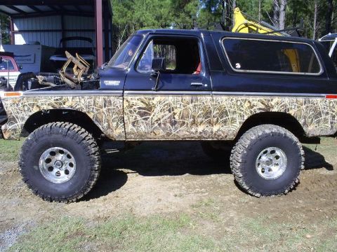 1979 Ford Bronco - This lifted Ford Bronco features a camouflage wrap and large off-road tires.