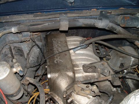 1995 Ford Bronco - Close-up view of a vehicle's engine bay, showing the intake manifold and associated components.