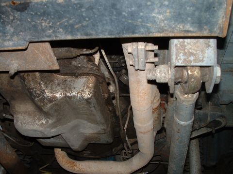 1995 Ford Bronco - A view of the underside of a vehicle, focusing on the transmission and exhaust system components.