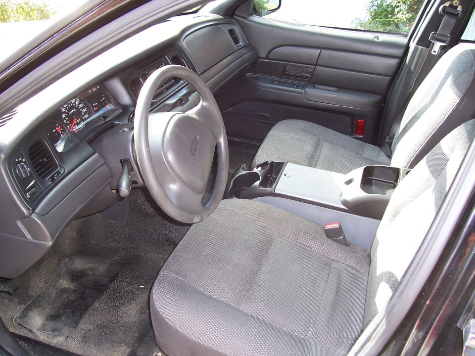 Interior of a 2003 Ford Crown Victoria showing the dashboard, steering wheel, and front seats
