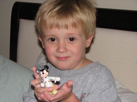 1991 Ford Bronco - A young boy holds a Mickey Mouse toy dressed as a Jedi.