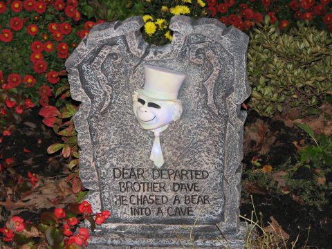 1991 Ford Bronco - A tombstone with a ghostly figure and a humorous epitaph is surrounded by red and yellow flowers.