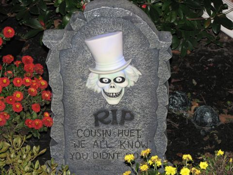 1991 Ford Bronco - A Halloween decoration gravestone features a ghost with a top hat and the inscription 'RIP Cousin Huet, We All Know You Didn't Go'.