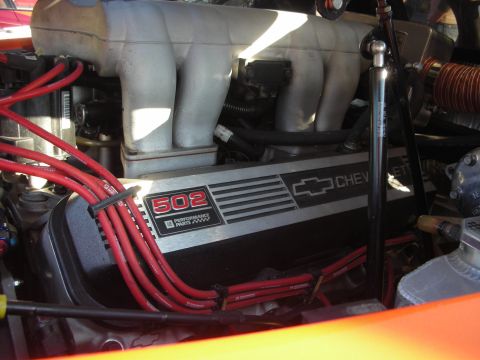 1998 Ford Crown Victoria - Close-up of a Chevrolet 502 big-block engine, its valve cover bearing the bowtie logo and 502 Performance Parts text amid red plug wires.