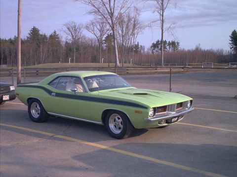 2000 Ford Crown Victoria - A classic muscle car is parked at a drag strip with trees and a fence in the background.