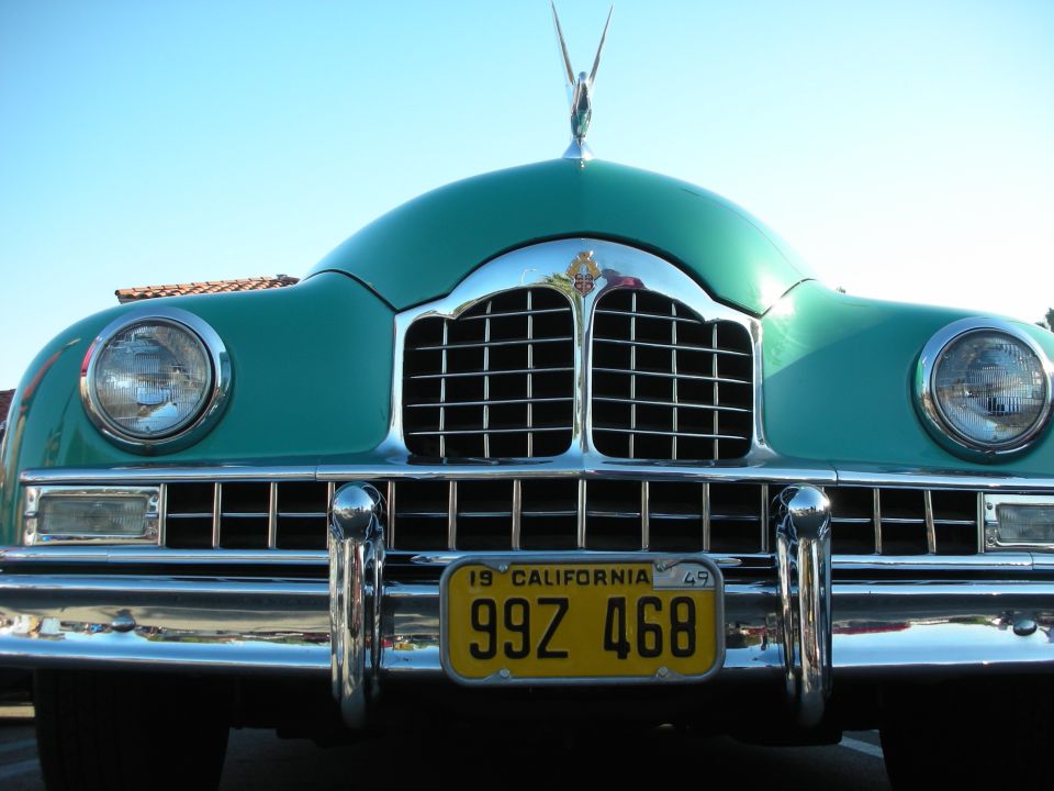 Front of green 1949 vintage car, chrome grille, dual headlights, California plate 99Z 468