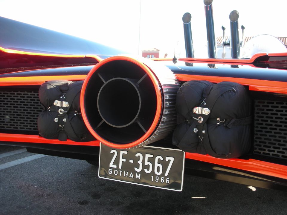 Black and red car rear with large turbine exhaust and 'GOTHAM 1966' plate reading 2F-3567