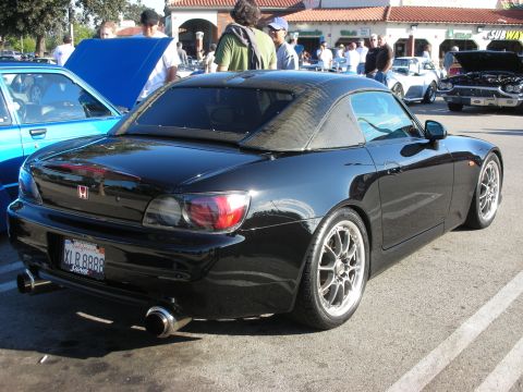 1998 Ford Crown Victoria - Rear three-quarter view of a black Honda convertible with hardtop, silver wheels, and a California plate reading XLR8888 at a car show.