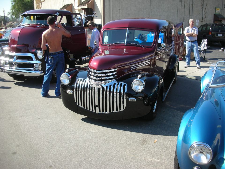 Maroon 1940s Chevrolet panel/sedan delivery at an outdoor car show