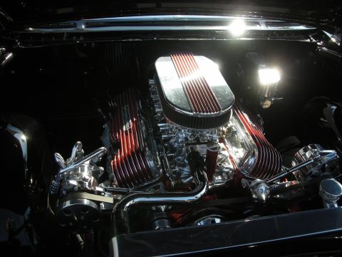 1998 Ford Crown Victoria - Close-up of a polished V8 engine bay, custom red valve covers and a chrome air filter housing.