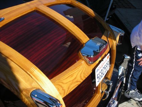 1998 Ford Crown Victoria - Close-up of a woodie wagon's rear, showing detailed wood grain and chrome accents.