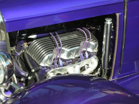 1998 Ford Crown Victoria - The engine bay of a custom hot rod features a polished aluminum intake manifold and chrome valve covers.