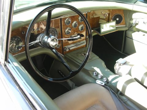 1998 Ford Crown Victoria - The luxurious interior of a vintage automobile features a detailed dashboard with numerous gauges and a prominent steering wheel.