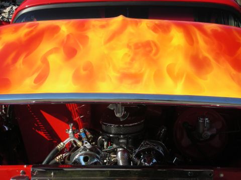 1998 Ford Crown Victoria - Custom flame skull paint adorns the hood, revealing a detailed engine bay with chrome accents.