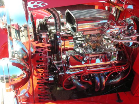 1998 Ford Crown Victoria - Custom V8 engine with chrome components and flame graphics, likely from a hot rod.