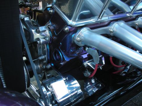 1998 Ford Crown Victoria - A detailed view of a custom V8 engine, polished chrome components and a uniquely colored engine block.