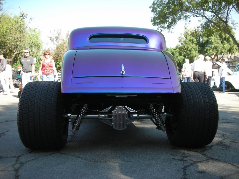 Rear view of purple hot rod coupe with huge rear tires and exposed suspension