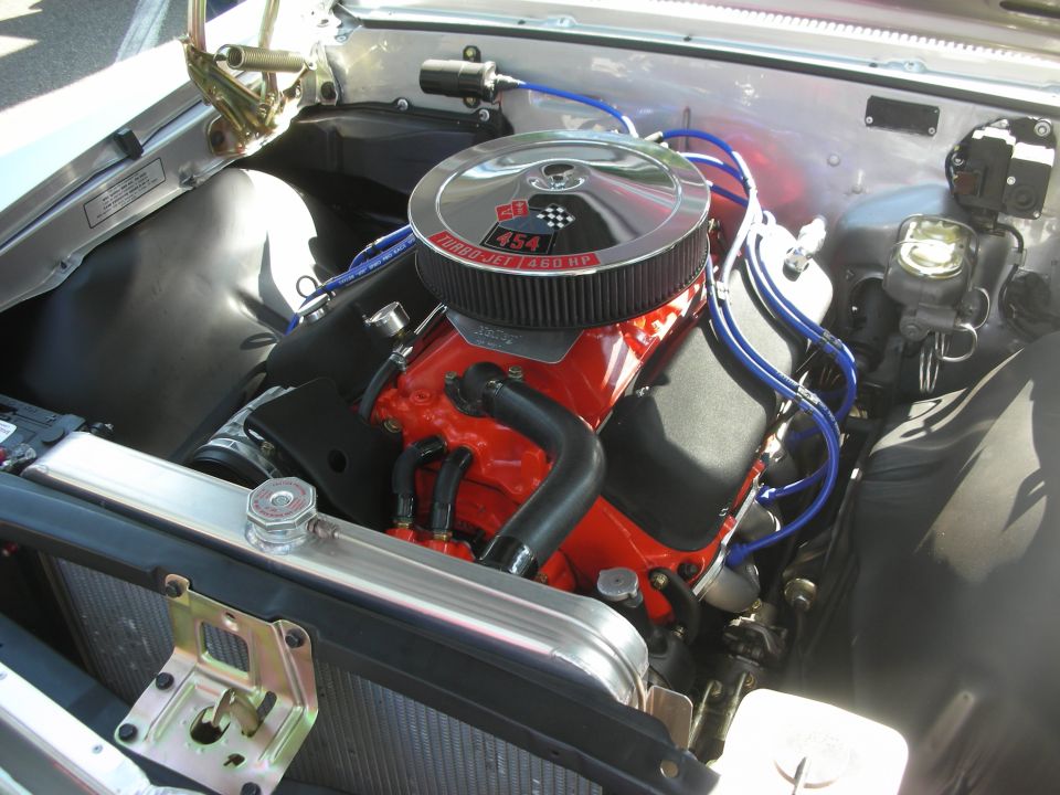 Red 454 big-block engine with blue plug wires and chrome air cleaner