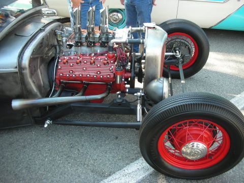 1998 Ford Crown Victoria - Custom hot rod with a V8 engine and red wire wheels, seen at a car show.