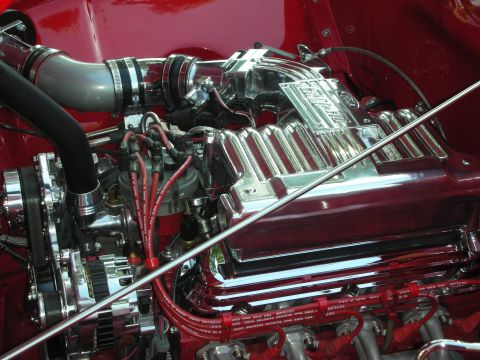 1998 Ford Crown Victoria - Engine detail shot showing chrome components and red spark plug wires.