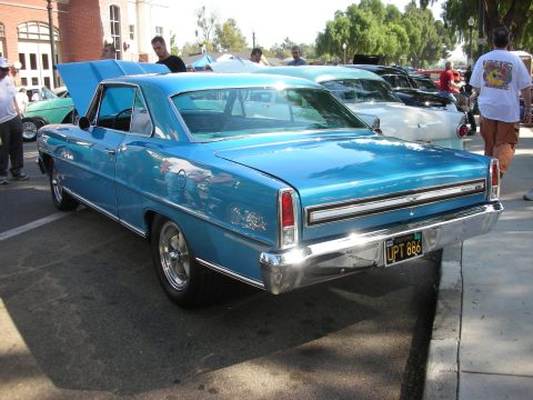 1998 Ford Crown Victoria - Rear view of a blue 1966 Chevrolet Nova at a car show.