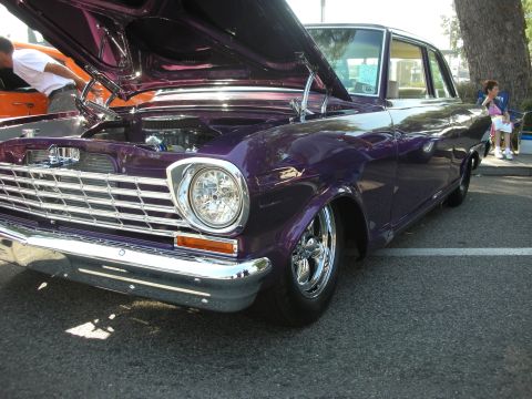 1998 Ford Crown Victoria - Purple classic car with hood open at a car show, custom wheels and chrome details.