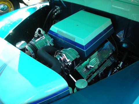 1998 Ford Crown Victoria - Close-up view of a custom engine bay a polished V8 engine and a two-tone air cleaner assembly.