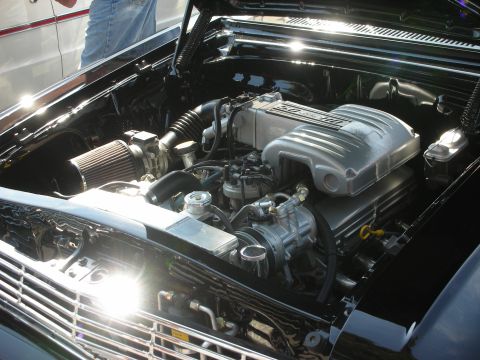1998 Ford Crown Victoria - The engine bay of a classic car is shown with a polished V8 engine and chrome accents.