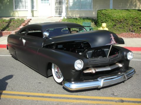 1998 Ford Crown Victoria - A custom hot rod coupe with its hood open is parked on a street in front of a house.