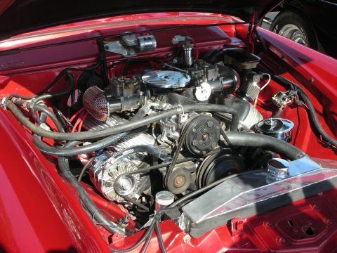 1998 Ford Crown Victoria - Close-up of a V8 engine bay dual carburetors and custom aluminum radiator.