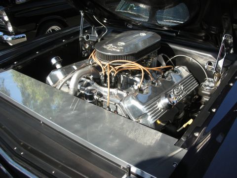 1998 Ford Crown Victoria - The engine bay of a classic car features a polished V8 engine with custom detailing.