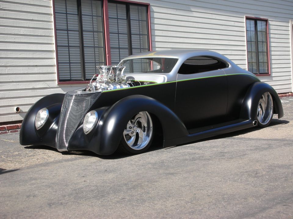 Black-and-silver 1937-style coupe hot rod with exposed blower engine