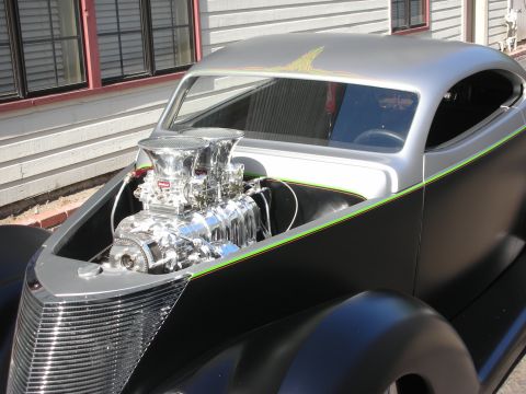 1998 Ford Crown Victoria - This custom hot rod features a prominent chrome engine with dual carburetors, a two-tone black and silver paint scheme, and custom pinstrip…