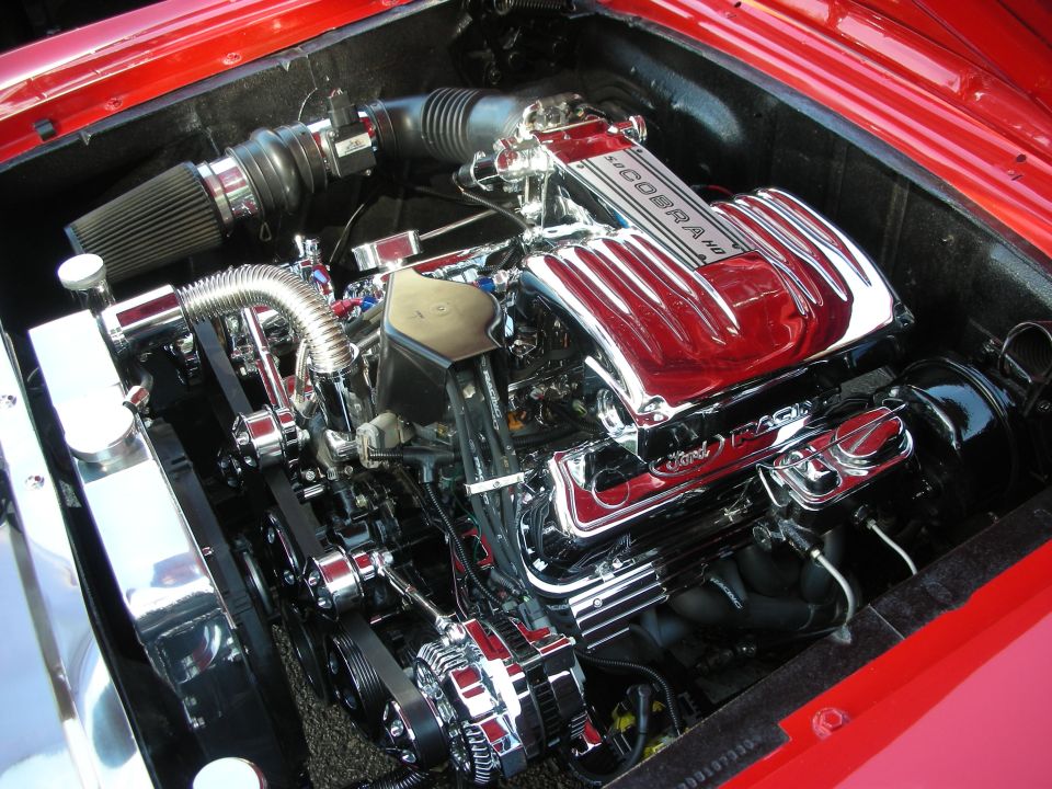 Chrome-dressed Chevrolet Corvette LS engine in a red engine bay