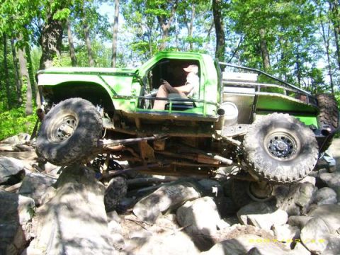 1978 Ford Bronco - This heavily modified off-road vehicle is shown navigating a challenging rocky course.