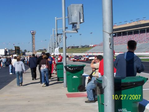 1979 Ford F-150 - Spectators watch race cars on a track with grandstands in the background, dated October 27, 2007.