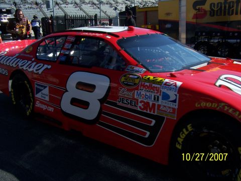 1979 Ford F-150 - A red NASCAR race car with the number 8 is seen up close with various sponsor logos on its side.