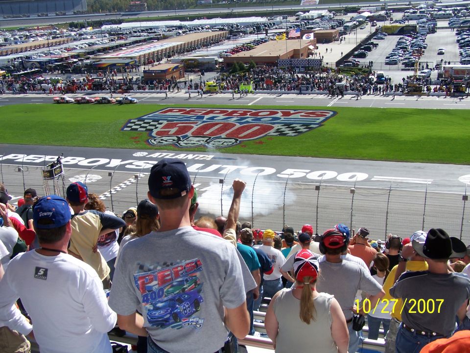 Pep Boys 500 race logo on grass, race cars on track, spectators in stands, date 10/27/2007