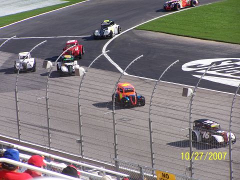 1979 Ford F-150 - A group of colorful, vintage-style race cars are captured in action on a sunny day at the track, with a visible date stamp of October 27, 2…