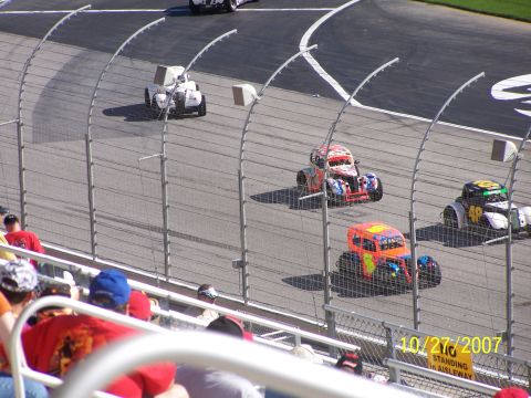1979 Ford F-150 - Multiple stock cars compete on a race track, with spectators in the foreground and a date stamp of 10/27/2007 visible.