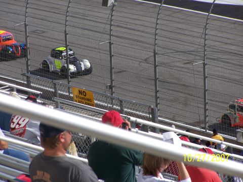 1979 Ford F-150 - Stock cars compete on a race track, with spectators in the foreground.
