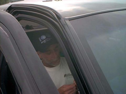 2000 Ford Crown Victoria - A man is seen inside the car's interior, wearing a hat and a t-shirt.