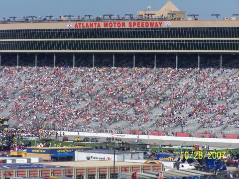 1979 Ford F-150 - A wide view of the Atlanta Motor Speedway filled with fans on race day.