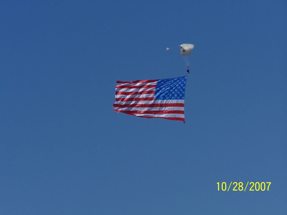 American flag and skydiver against blue sky, dated 10/28/2007