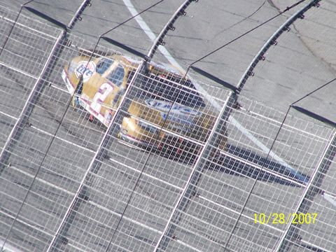 1979 Ford F-150 - Race car with number 12 and Miller Lite sponsorship on track, viewed through a fence. Dated 10/28/2007.