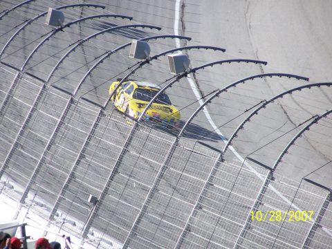 1979 Ford F-150 - A yellow race car speeds around a track, captured on October 28, 2007.